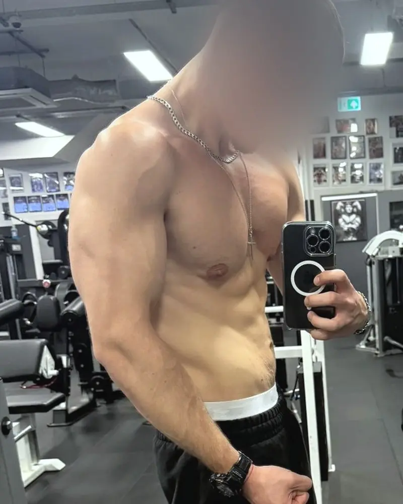 Pi noy later: a mirror photo in a gym, flexing, face blurred.
